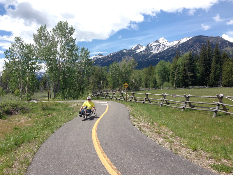 Handcycle on Teton multi-use path with the Teton Range in the background
