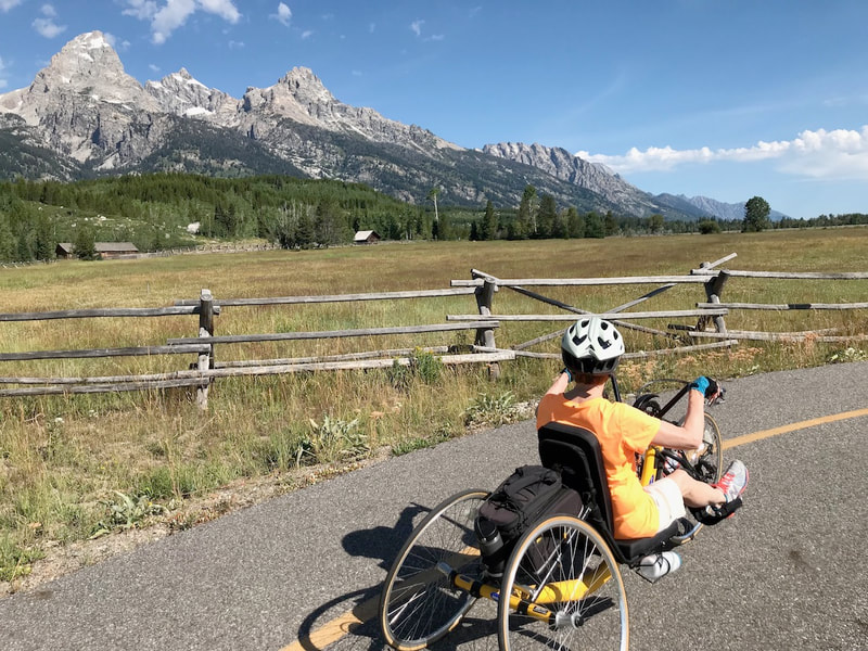 Handcycle on Teton multi-use path with the Teton Range in the background